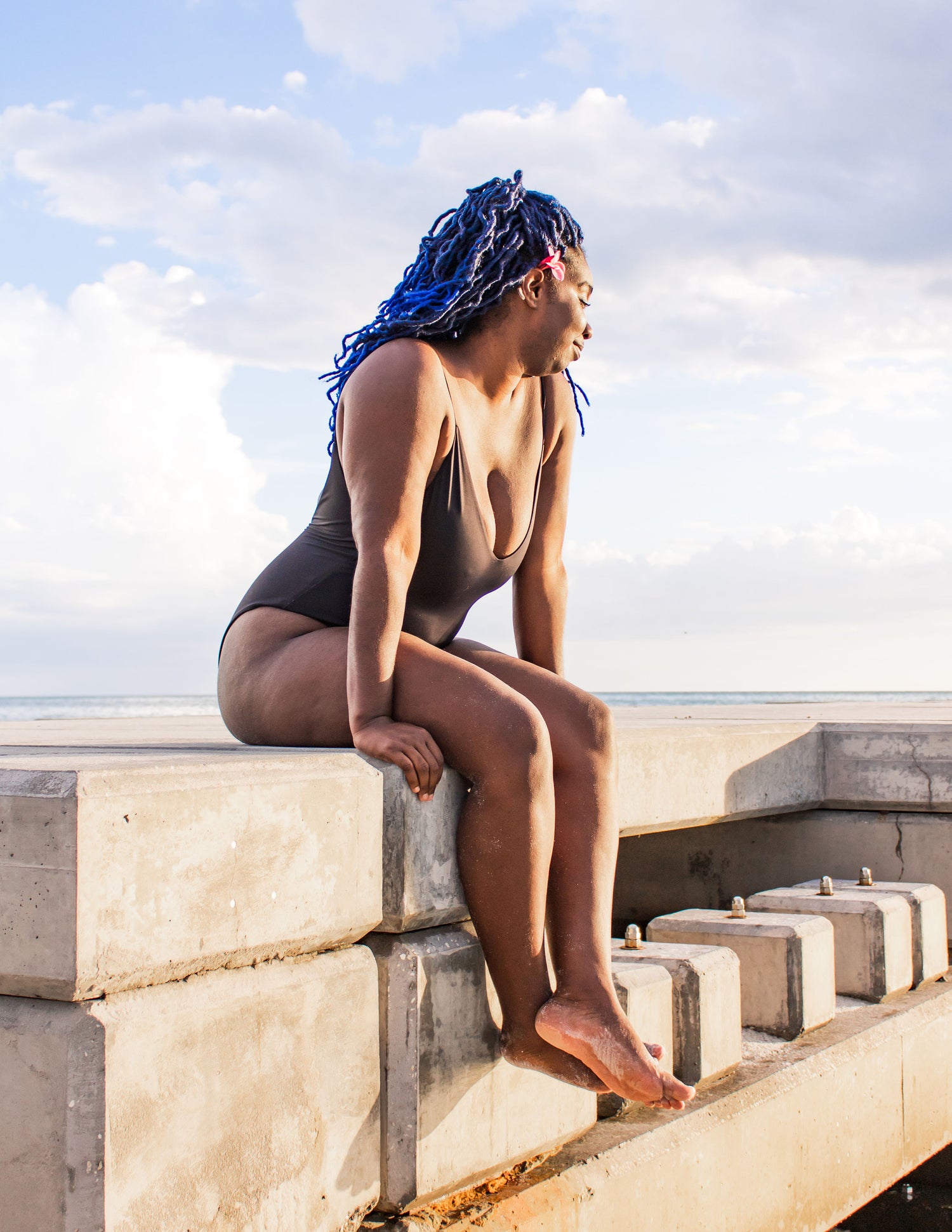 black slimming one piece swimsuit made from recycled materials flattering on all body types